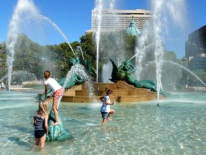 kids playing in fountain